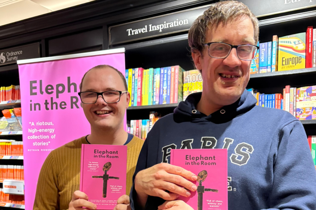 Kyle and Josh, two members of the Grace Eyre Creative Group stand holding their book 'Elephant in the Room'