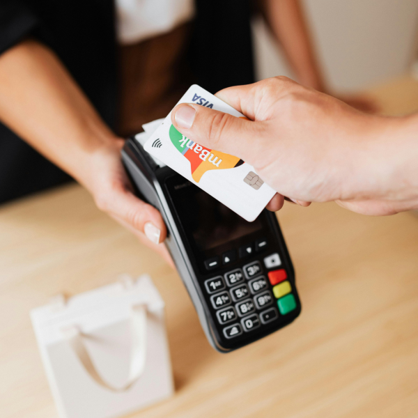A hand making a card payment