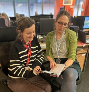 Anya and her job coach at work in Grace Eyre